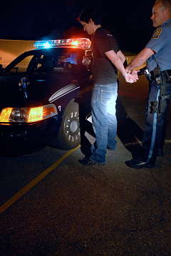 Police man handcuffing man